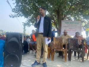 Bhola Bhattarai delivering speech during community action at Nijgadh