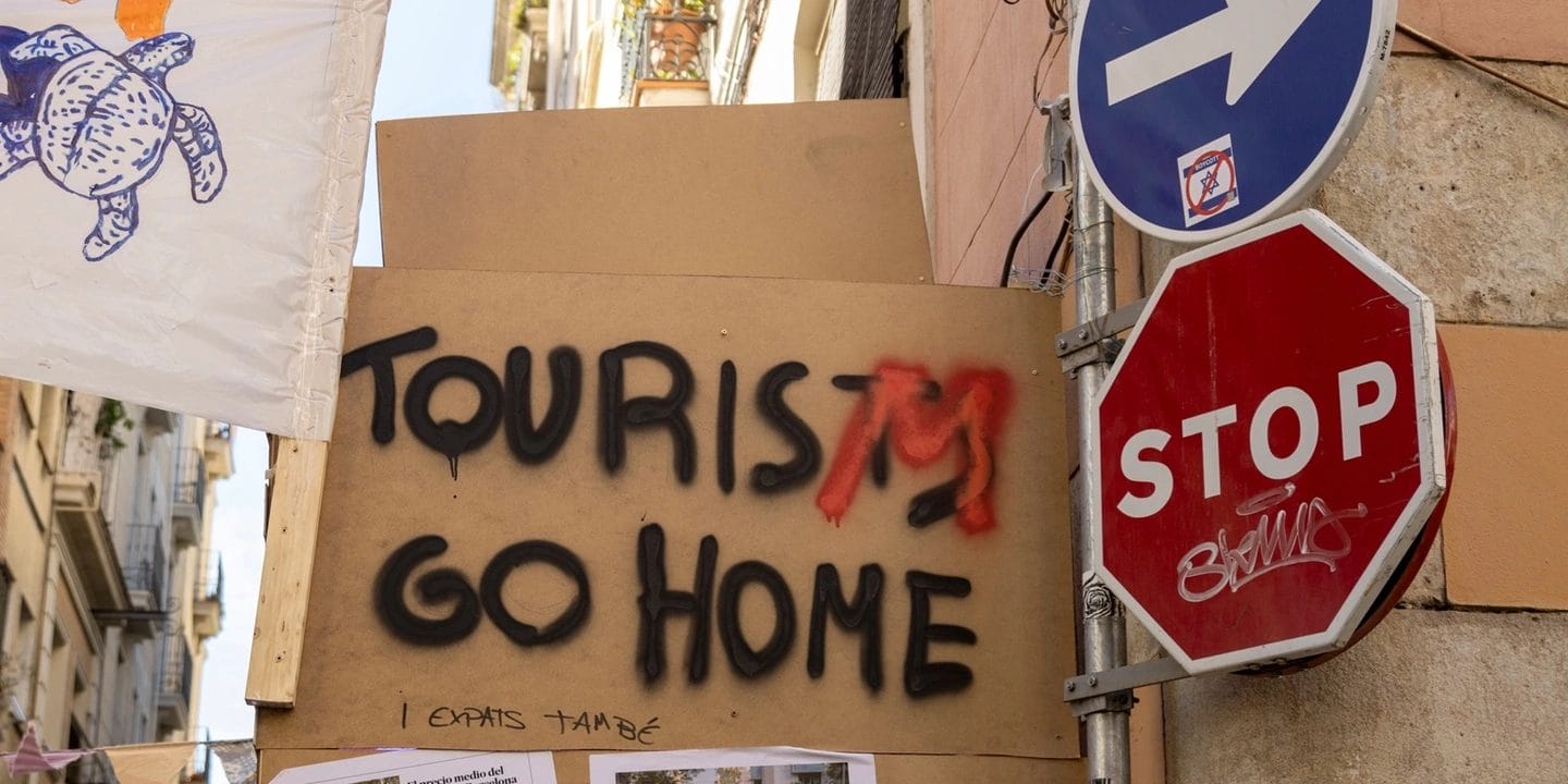 Flight Free Australia's photo of a 'tourists go home' banner